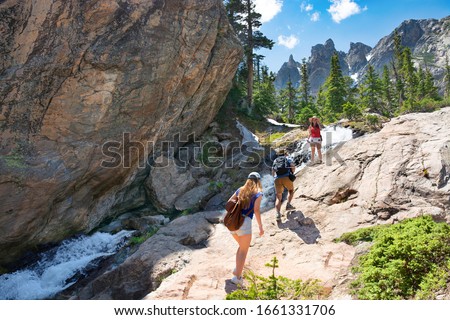 Family on summer vacation trip in the  mountains. People hiking on Emerald Lake Trail. Friends exploring Colorado mountains. Estes Park, Rocky Mountains National Park, Colorado, USA. Royalty-Free Stock Photo #1661331706