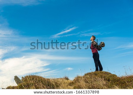 man freedom pose mountain top successful concept foreshortening from below blue sky vivid background empty copy space for your text here wallpaper poster concept picture  