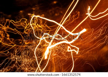 Abstract Light painting with candle light - blurred lights background.