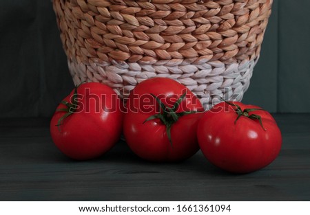 image of fresh red tomatoes and salad seen from above on dark background ready to cook