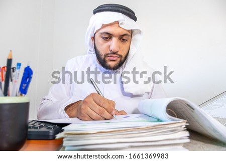 Arabic muslim man working on some paper