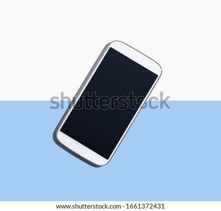 White smartphone with black screen from above - flat lay