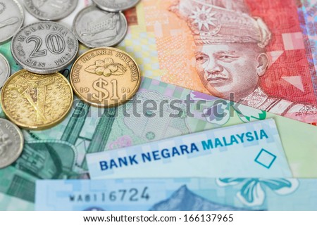 Malaysian money ringgit banknote and coins close-up (focus on coin)