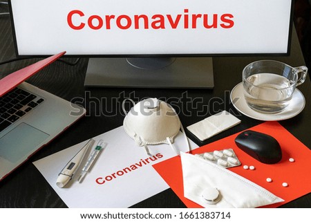 Coronavirus quarantine concept, remote work from home. Background with computer, laptop, medicines, protective masks, thermometers and warm water cup. 
