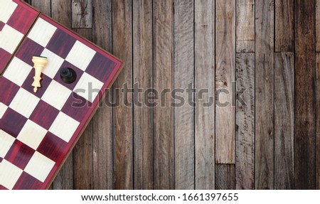 Business Competition Concept : Top view portable chess board on wooden table.