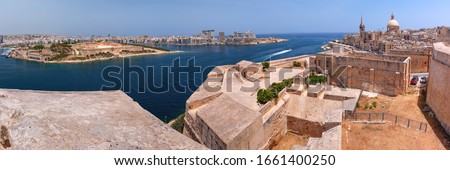 Sliema and Old town of Valletta with fortress, Our Lady of Mount Carmel church and St. Paul's Anglican Pro-Cathedral at sunset, Capital city of Malta