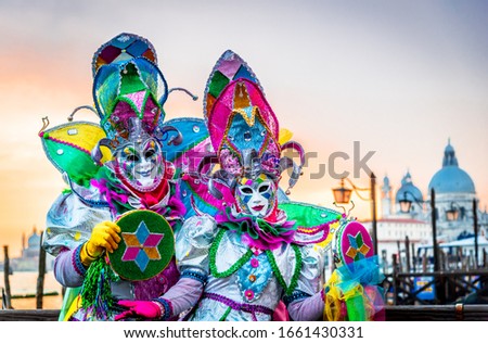 Venice, Italy, venetian masked model from the Venice Carnival, with Gondolas in the background, Grand Canal