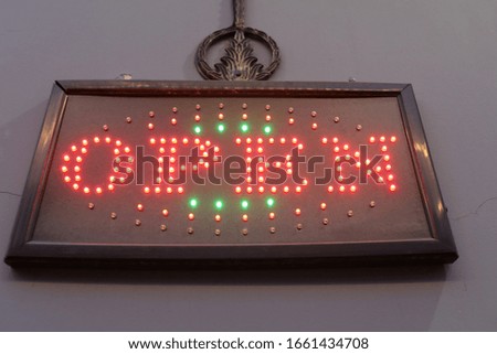 View of glowing sign open on wall in restaurant