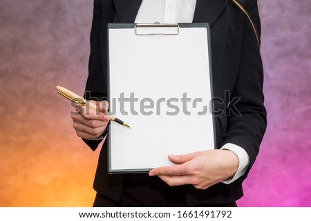Beautiful woman with clipboard offering sign a contract with pen