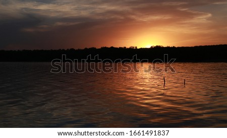 bright orange sunset on the lake