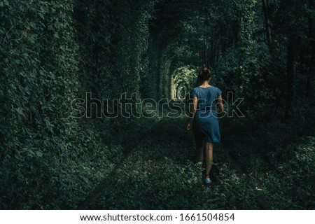 Young woman walking through the tunnel of love in Orzhiv, Ukraine. 