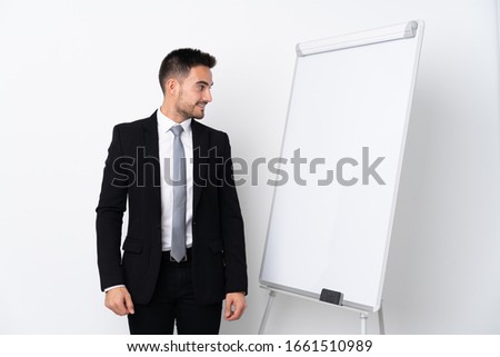 Young man giving a presentation on white board and looking side