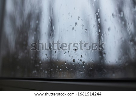 Window in the raindrops. Rainy day. Window in the drops.