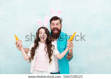 Spring holiday. Celebrate easter. Easter food. Girl and dad bunny ears. Happy family wear bunny ears. Easter fun and happiness. Father and daughter play with carrots. Shopping grocery. Funny team.
