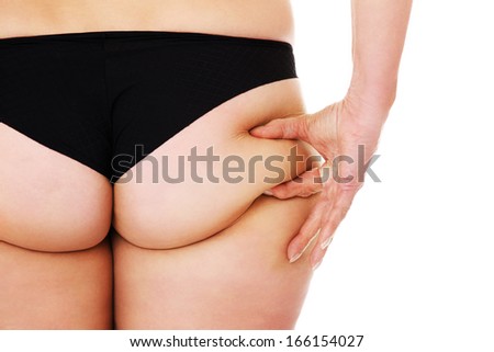A picture of the back of a mature woman showing fat over white background