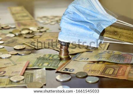 money metal hammer in the anti-virus bandages hits the coins viruses destroy the economy Royalty-Free Stock Photo #1661545033