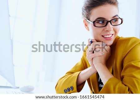 Business woman with desktop reading document at her office
