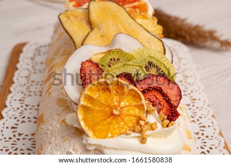 Juicy sliced meringue cake with dried fruits