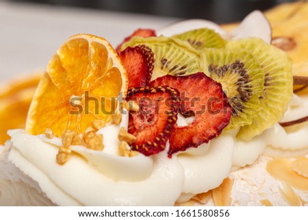 Juicy sliced meringue cake with dried fruits