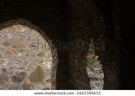 Ancient buildings and ruins, stone walls and arches, walkways and doorways, basements and steps. Views of the landscapes and buildings. There are public places on the streets in Georgia.