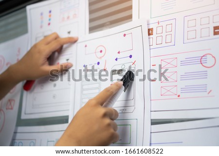woman design engineer for ux architect template framework layout developer project mobile application on wall paper work in office with pen. Planning of development in program website interface ideas