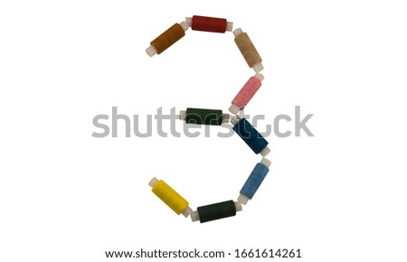 Isolated Font number 3 or Russian letter made of colorful spools of thread for sewing on white background