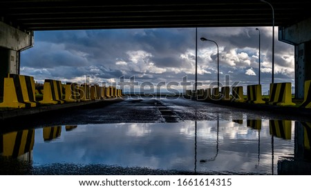 
Fragment of a road under construction against the background of the Gulf of Finland skyline