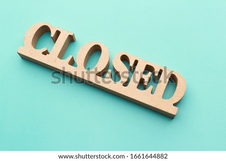 "closed" wooden sin board with blue background. restaurant sign board.
