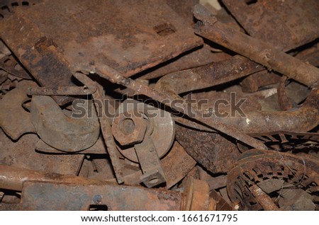 Rusty scrap metal lies in bulk.