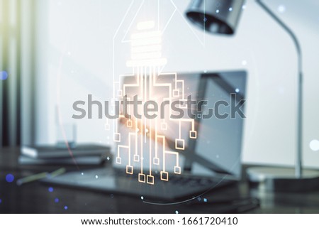 Double exposure of creative light bulb hologram with chip on laptop background, idea and brainstorming concept
