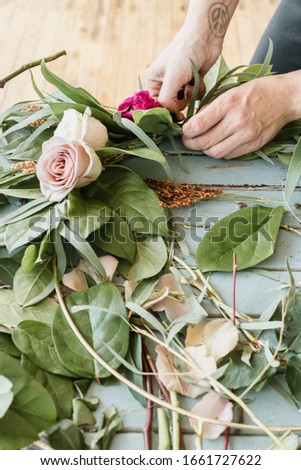 Small business. Women florist in flower shop. Floral design studio, making decorations and arrangements. Flowers delivery, creating wedding wreath 