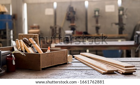 Carpenter working with equipment on wooden table in carpentry shop. woman works in a carpentry shop. Royalty-Free Stock Photo #1661762881