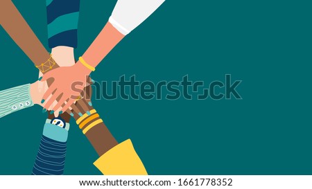 Different people join hands in a fit of teamwork. A group of people strives for a common goal in their work. Together strength, confidence and result. Friendship and helping each other in unity. Royalty-Free Stock Photo #1661778352