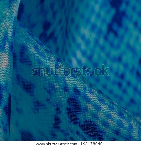 Background, texture, pattern, silk-white fabric with a pattern of blue squares of lines