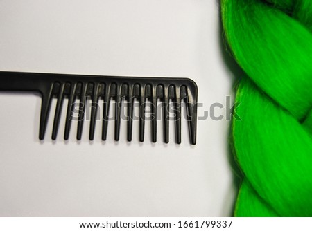 Kanekalon. Colored artificial hair strands. Synthetic hair materials for weaving African braids zizi. Close-up of bright colored hair. Overhead locks. Background for business cards. Green colors.