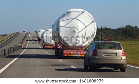 Oversize trucks convoy with escort car driving on suburban highway road at Sunny summer day, oversized logistisc business Royalty-Free Stock Photo #1661808979