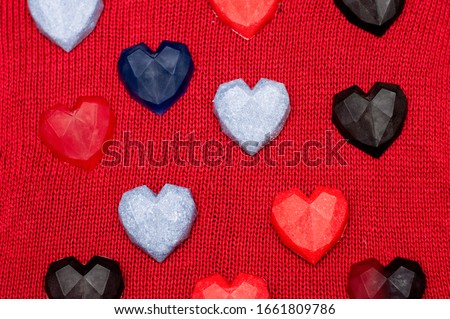 multicolored hearts on a red knitted background. Romantic picture.  Valentine's day card. Mother's day. The eighth of March. Holidays. 