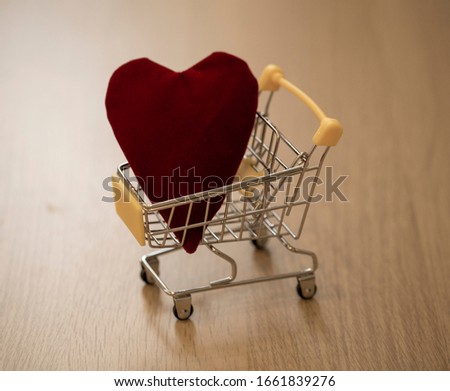 heart in a grocery cart. concept photo about love and the price of love in bright colors