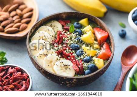 Superfood smoothie in coconut bowl with fruits and seeds toppings. Healthy eating, healthy lifestyle concept Royalty-Free Stock Photo #1661844010