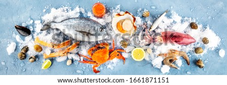 Fish and seafood overhead panoramic shot. Sea bream, scallop, crab, squid, clams and prawns