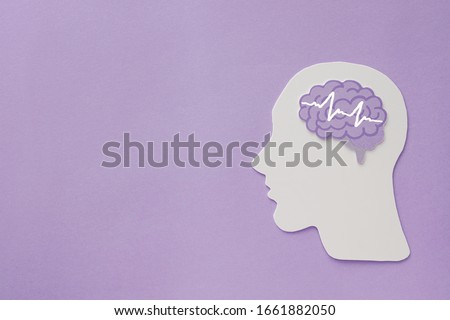 encephalography brain paper cutout on purple background,autism, Epilepsy and alzheimer awareness, seizure disorder, world mental health day concept Royalty-Free Stock Photo #1661882050