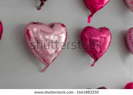 Pink heart shaped foil baloons on a wall love concept, Holiday celebration, Valentine's Day 