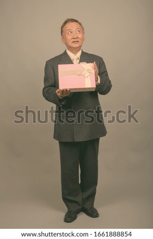 Portrait of mature Asian businessman ready for Valentine's day