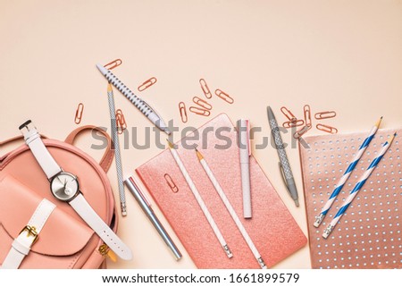 Set of school supplies with backpack on color background