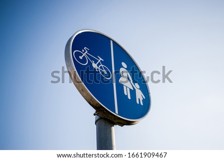 Bicycle and pedestrian lane, path blue round road sign on pole post