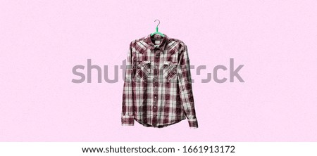 a simple checkered shirt on a hanger on a wall, minimalist abstract concept at home