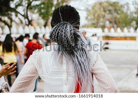 Portrait of beautiful asian girl with long braids hairstyle. Woman with braided hair. Braiding hair.