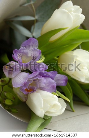 bouquet with white tulips, eucalyptus and lilac freesia