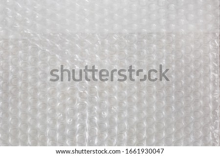 Fragment of sheet of plastic transparent bubble pack close-up, texture, background

