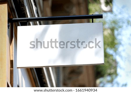 View of a Blank sign board on a shop wall 